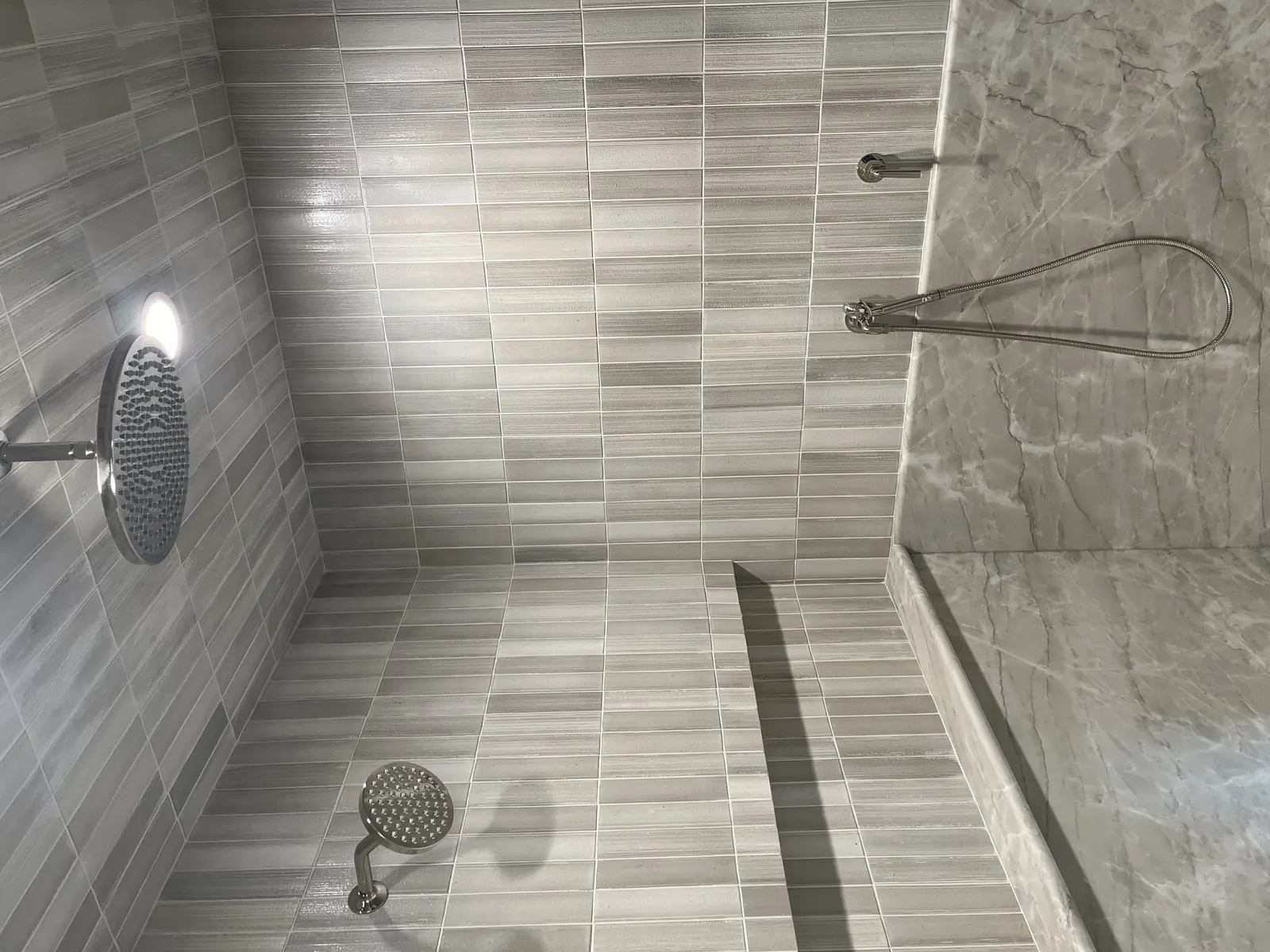 Large-format tiled shower with rain head