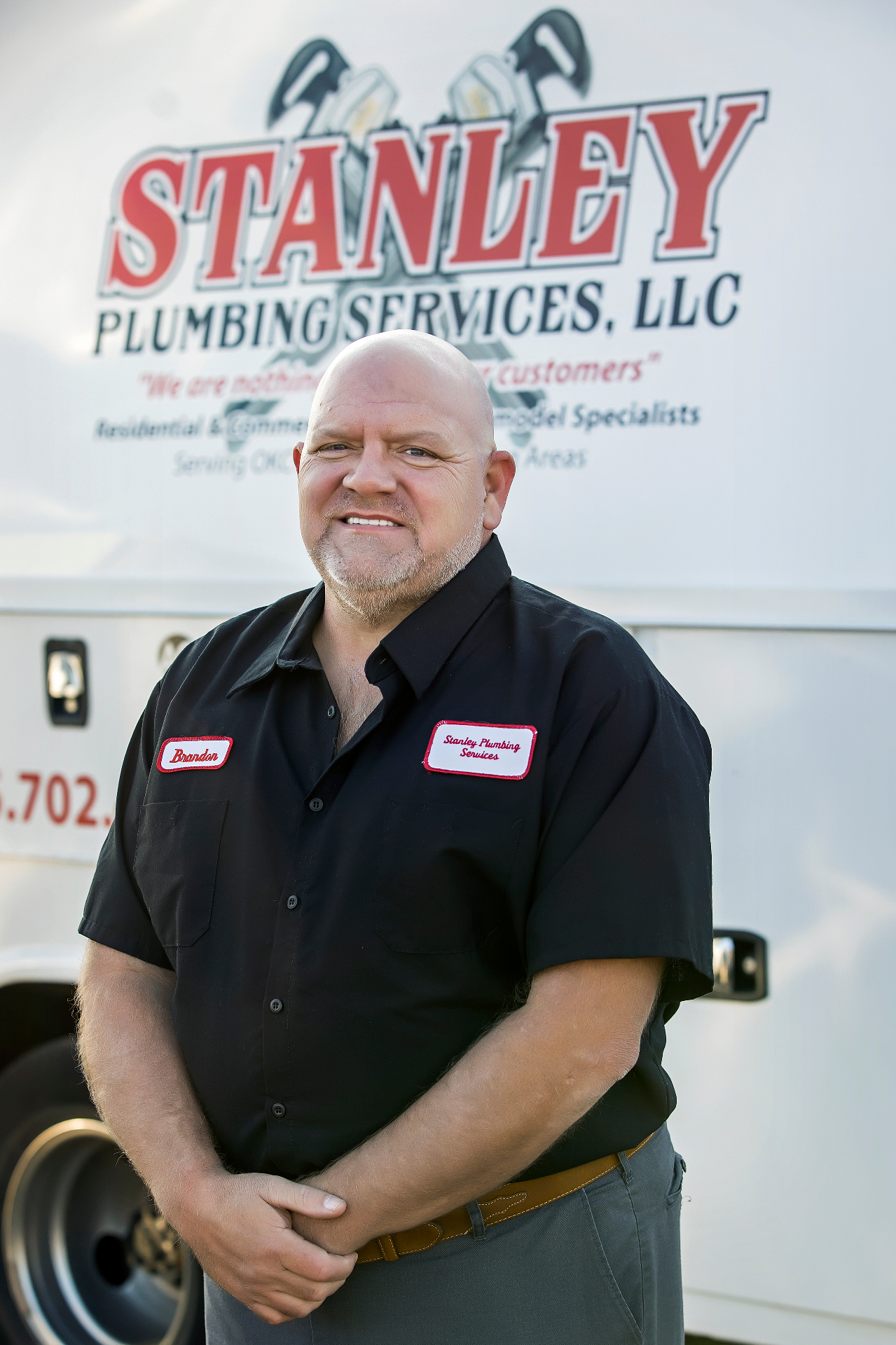 Brandon of Stanley Plumbing standing in front of a company service truck in Oklahoma City