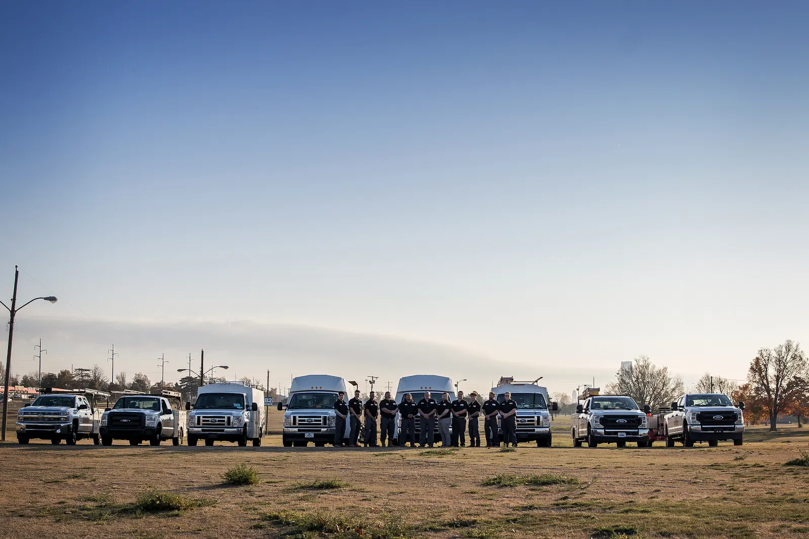 Stanley Plumbing fleet lined up with the crew