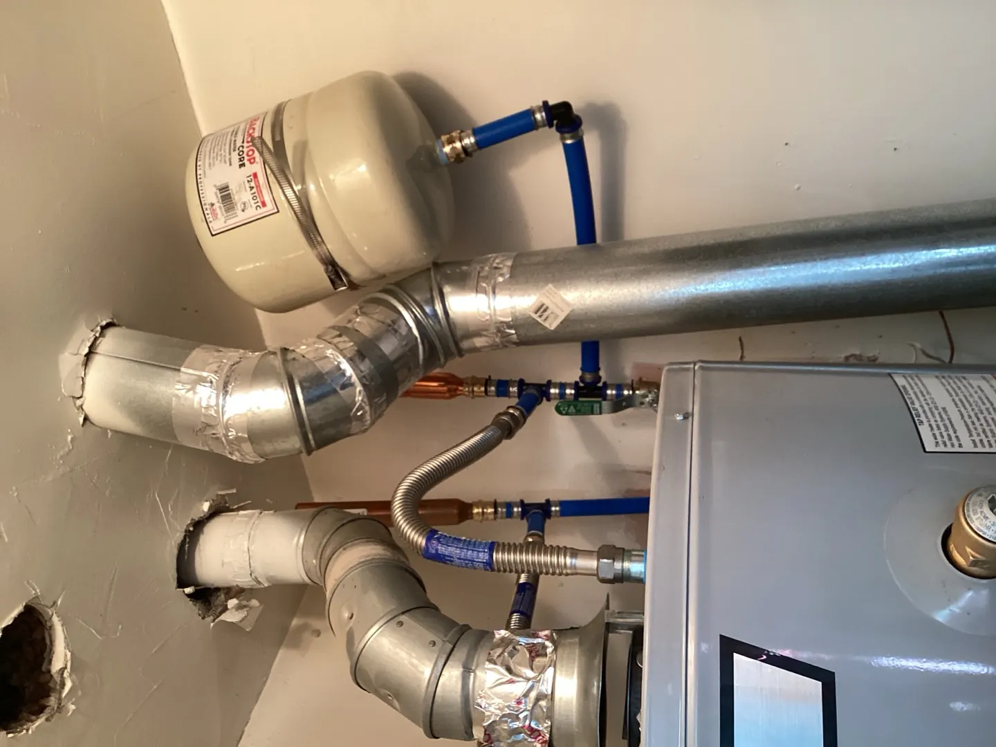 Fresh copper and PEX supply lines connected to a replacement water heater