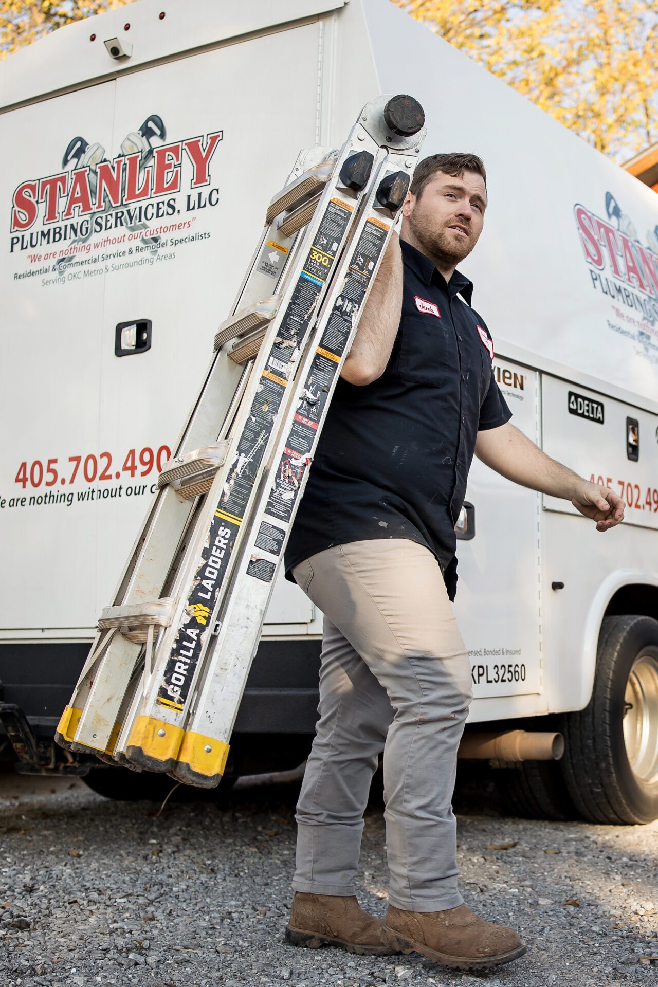 Two workers in uniform shaking hands at a doorstep